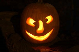 A carved pumpkin with a big nose smiling